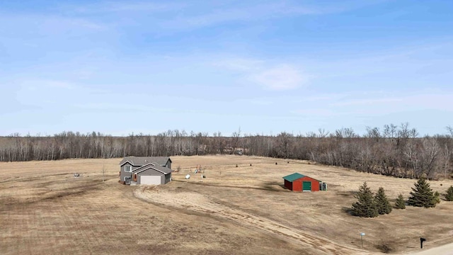 view of yard featuring a rural view and an outdoor structure