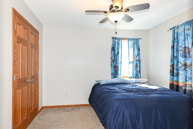 carpeted bedroom featuring baseboards and ceiling fan