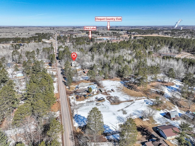 birds eye view of property with a view of trees