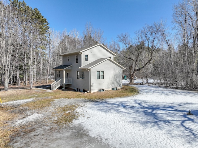 view of snow covered back of property