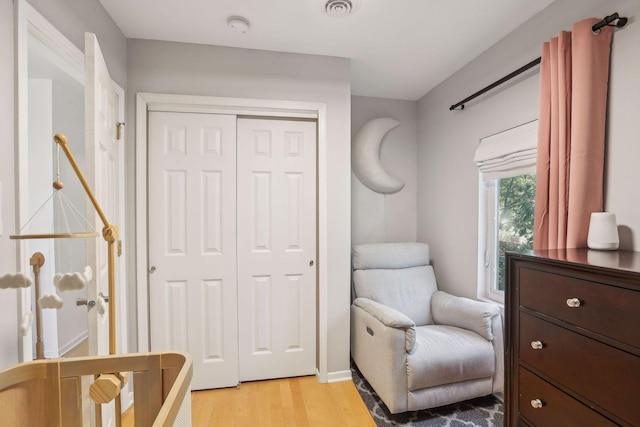 living area with visible vents and light wood finished floors