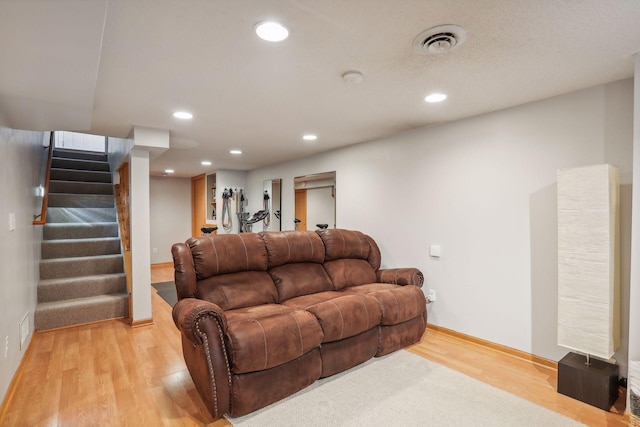 living area featuring visible vents, recessed lighting, stairs, and light wood-style floors