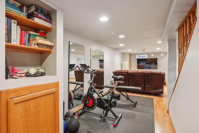 workout room featuring light wood-style flooring and recessed lighting