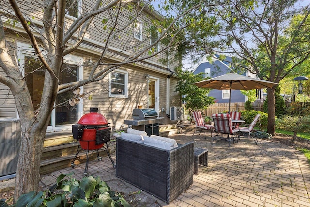 view of patio featuring area for grilling, outdoor dining area, fence, and cooling unit