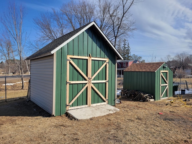 view of shed featuring fence