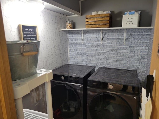 washroom featuring washer and clothes dryer and laundry area