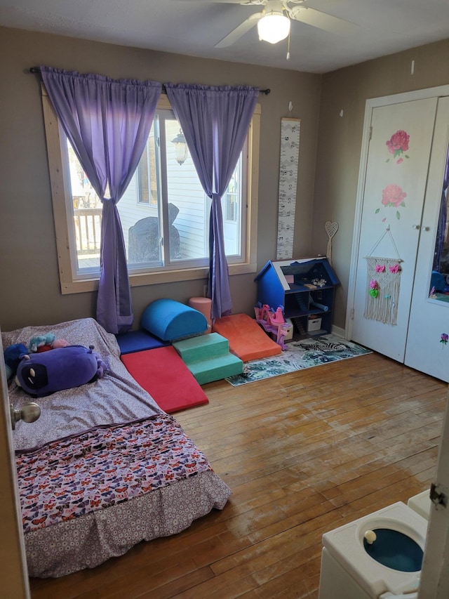 bedroom with ceiling fan and hardwood / wood-style flooring