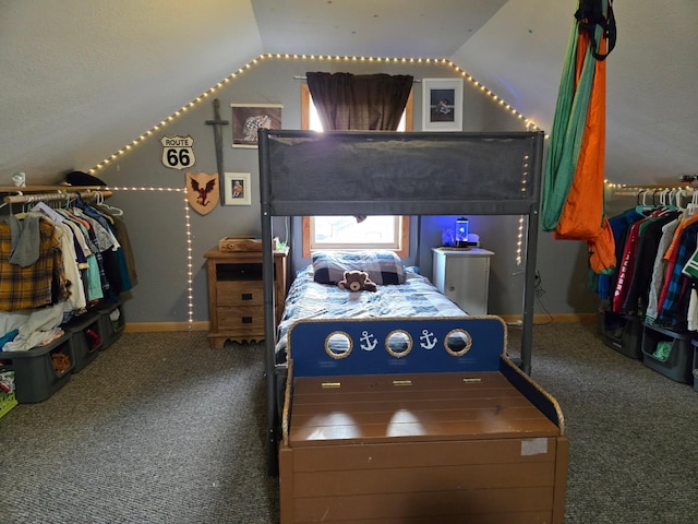 carpeted bedroom featuring baseboards and lofted ceiling