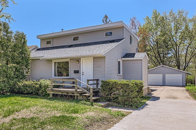 900 Park St, Anoka, MN 55303 - view of front of house featuring a shingled roof, a garage, and an outbuilding