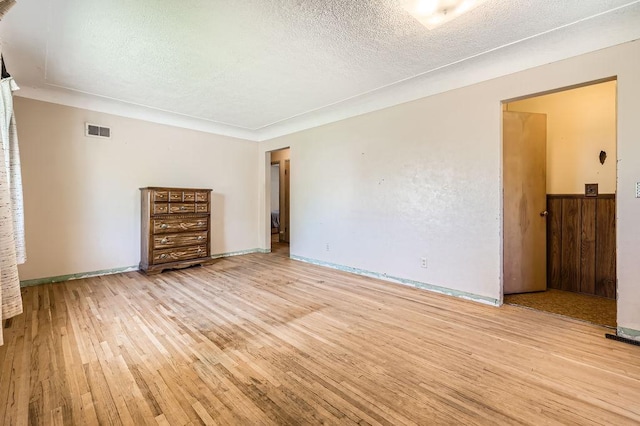 900 Park St, Anoka, MN 55303 - unfurnished living room featuring light wood-style floors and a textured ceiling