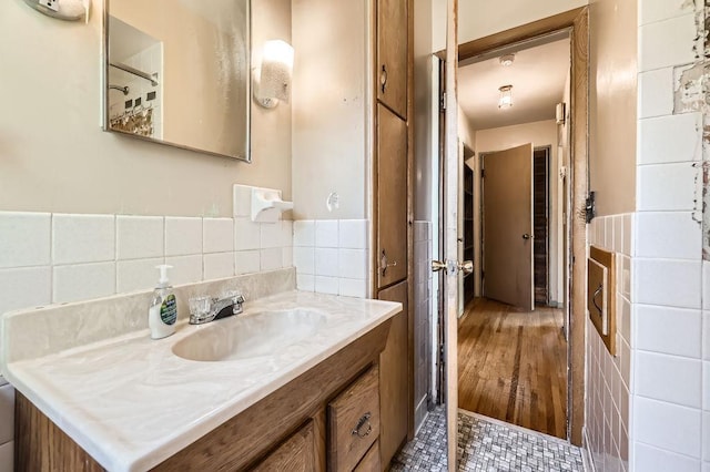 900 Park St, Anoka, MN 55303 - bathroom with tile walls, vanity, and a wainscoted wall