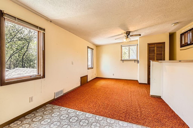 900 Park St, Anoka, MN 55303 - carpeted spare room with a textured ceiling, ceiling fan, and baseboards