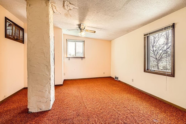 900 Park St, Anoka, MN 55303 - spare room featuring carpet, a ceiling fan, a textured ceiling, and baseboards