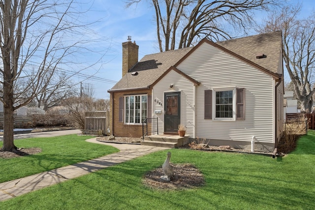 view of front of house featuring a chimney, a front lawn, and fence