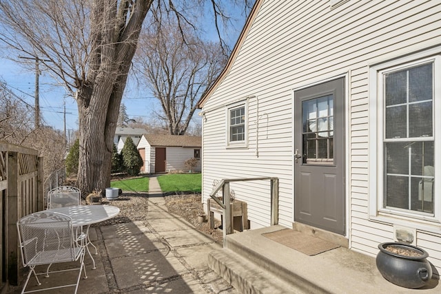 view of patio featuring an outbuilding