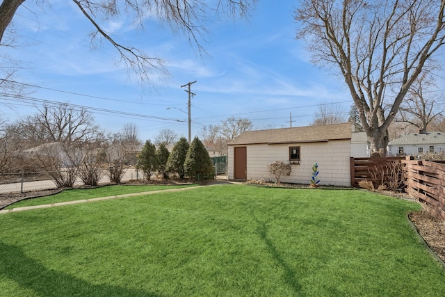 view of yard with an outdoor structure and a fenced backyard