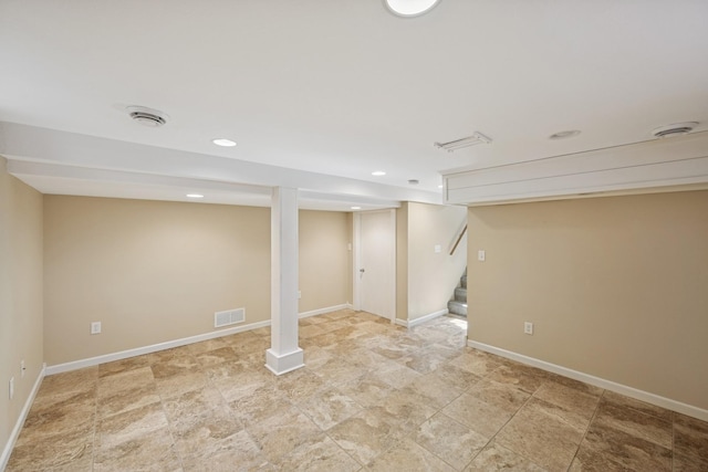 finished below grade area with recessed lighting, visible vents, baseboards, and stairs