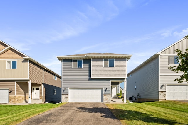 view of front of house with a front yard, an attached garage, and driveway