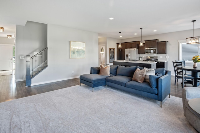 living room with dark wood-style floors, stairway, recessed lighting, and baseboards