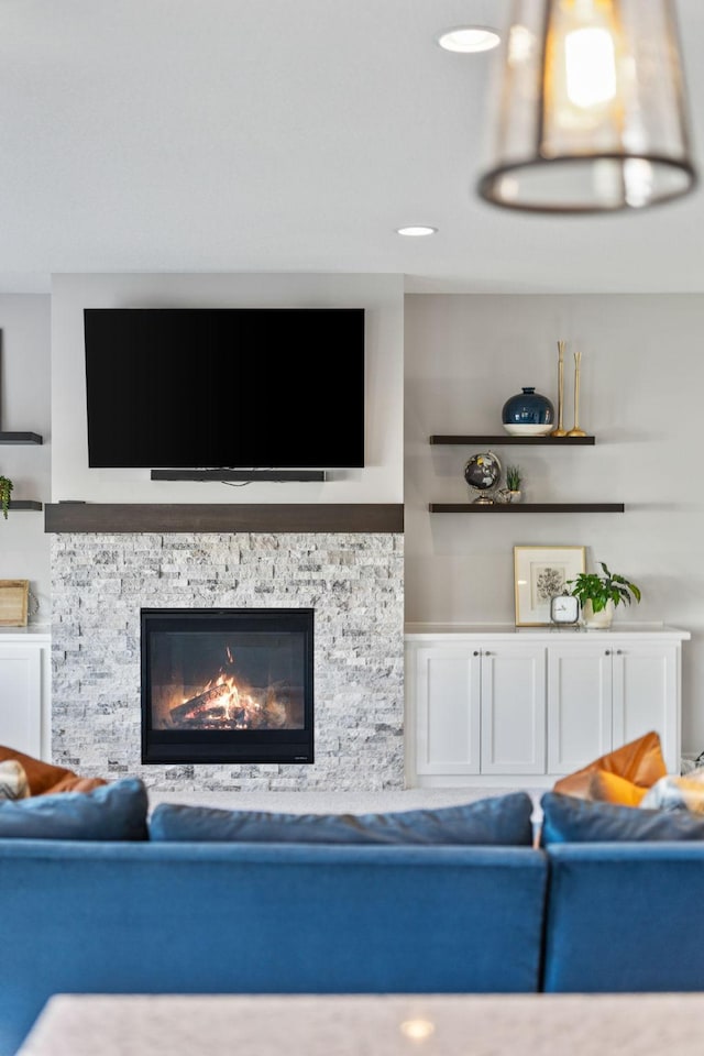 living room with a stone fireplace