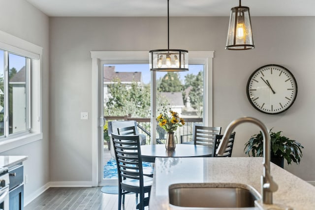 dining space featuring baseboards and wood finished floors