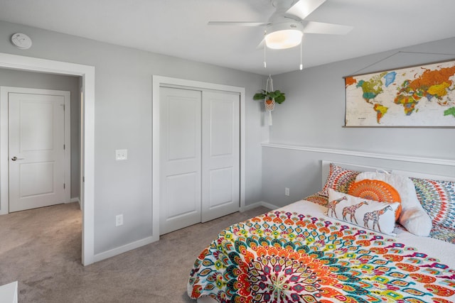 carpeted bedroom featuring a closet, baseboards, and ceiling fan