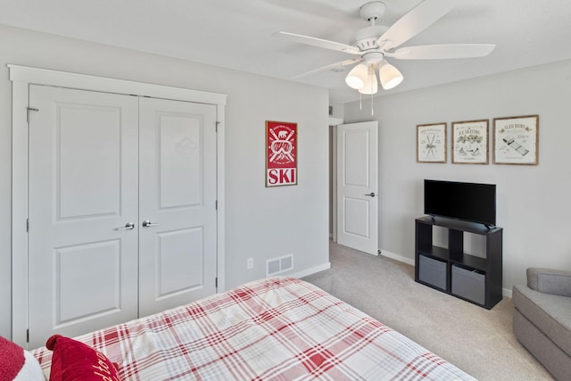 bedroom featuring visible vents, baseboards, carpet floors, a closet, and a ceiling fan