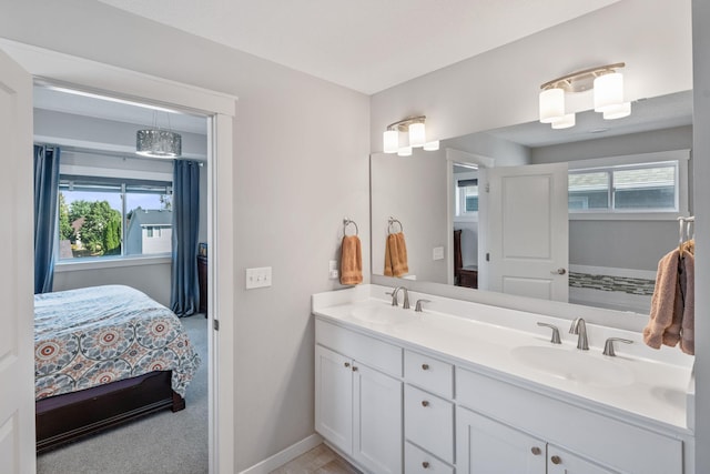 full bathroom with ensuite bath, a healthy amount of sunlight, and a sink