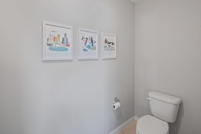 bathroom featuring tile patterned floors, toilet, and baseboards