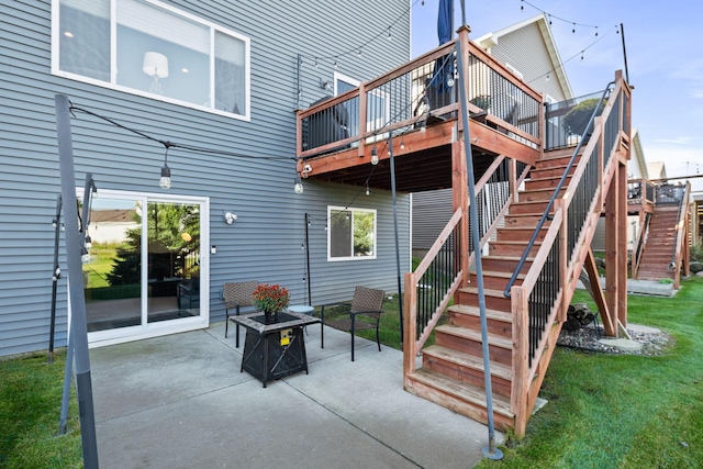 view of patio / terrace featuring an outdoor fire pit, a wooden deck, and stairs