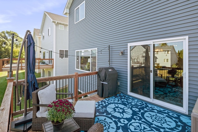 wooden deck with a grill