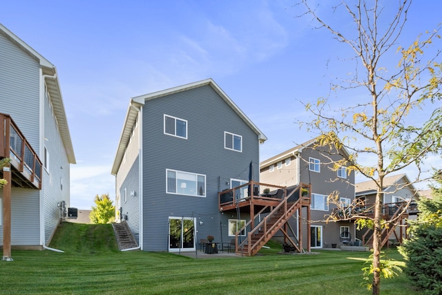 rear view of property featuring a wooden deck, stairs, cooling unit, a yard, and a patio