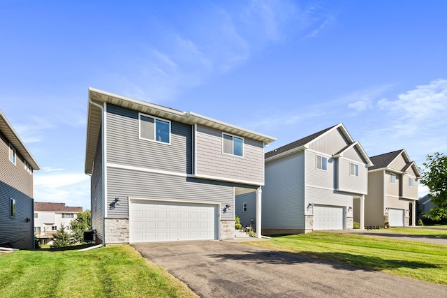 view of front of home featuring aphalt driveway, stone siding, a front yard, and an attached garage