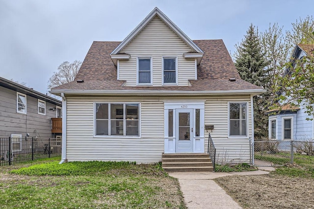 4250 32nd Ave S, Minneapolis, MN 55406 - bungalow featuring a shingled roof, fence, a front yard, and entry steps
