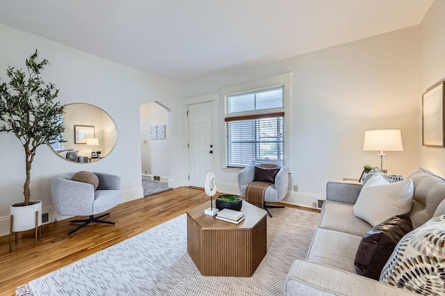 4250 32nd Ave S, Minneapolis, MN 55406 - living room with arched walkways, baseboards, and wood finished floors