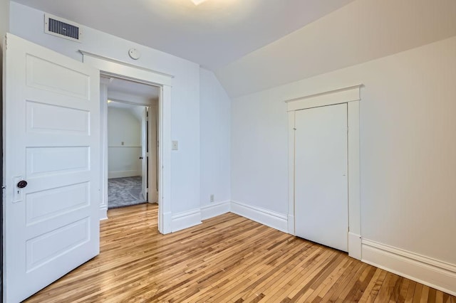 4250 32nd Ave S, Minneapolis, MN 55406 - unfurnished bedroom with baseboards, lofted ceiling, light wood finished floors, and visible vents