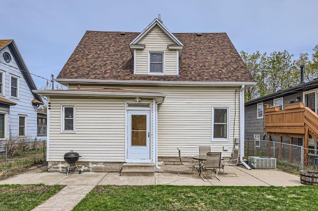 4250 32nd Ave S, Minneapolis, MN 55406 - rear view of house with a fenced backyard, central AC unit, a patio area, and roof with shingles