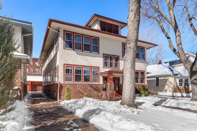 traditional style home featuring brick siding and stucco siding