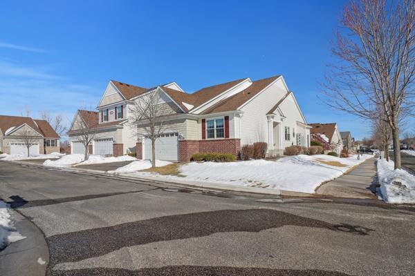 view of front facade with a garage, a residential view, and driveway