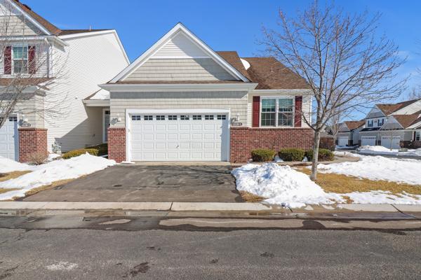 view of front of home with aphalt driveway, a garage, and brick siding