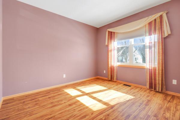 empty room with visible vents, baseboards, and light wood finished floors