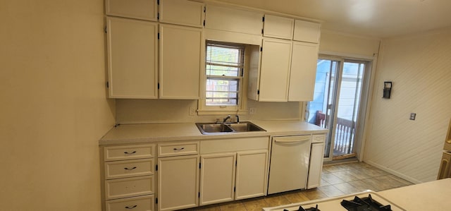 kitchen featuring dishwasher, light countertops, white cabinetry, and a sink