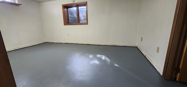 spare room with finished concrete flooring