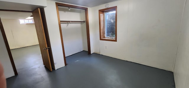 unfurnished bedroom featuring a closet and concrete flooring