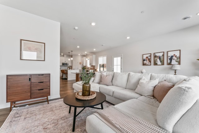 living area with recessed lighting and wood finished floors