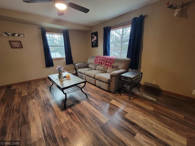 living room featuring wood finished floors, baseboards, and ceiling fan