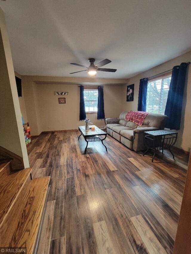 living room featuring a ceiling fan and wood finished floors