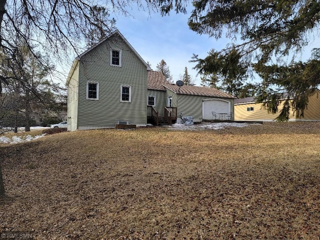 rear view of property featuring a garage