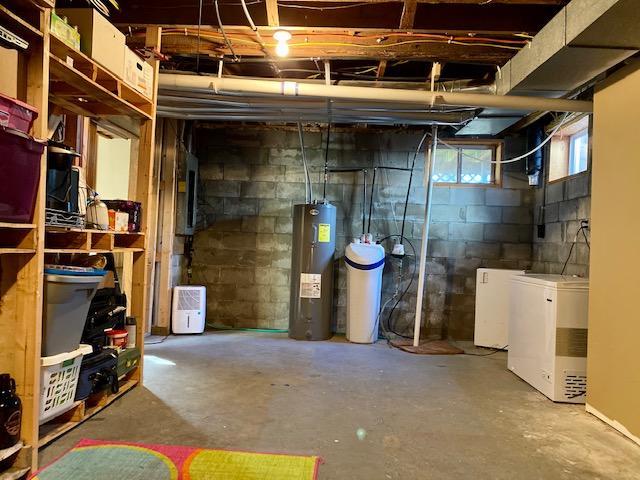 below grade area with refrigerator and water heater