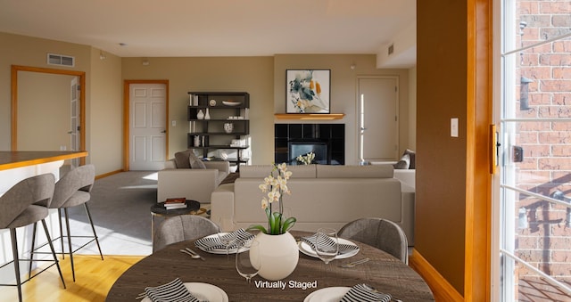 dining space featuring visible vents, baseboards, and a tile fireplace